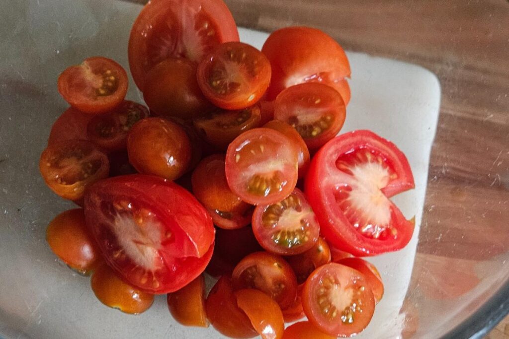 cute up tomatoes in a glass bowl.